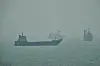 Commercial vessels anchored amid haze in the Strait of Hormuz off Bandar Abbas, Iran, on Sept. 7.