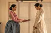 Son Ye-jin and NANA in traditional Korean dress, with Lady Cho presenting a tray to Hui-yeon.