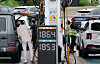 People fill their cars with fuel at a gas station in southern Seoul on Sept. 13.