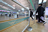 Air travelers walk toward check-in counters at Incheon International Airport's Terminal 1 on Aug. 19.
