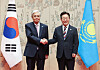Korean President Lee Jae Myung, right, shakes hands with Kazakh President Kassym-Jomart Tokayev at the Blue House in central Seoul on Sept. 15.