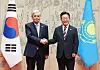 Korean President Lee Jae Myung, right, shakes hands with Kazakh President Kassym-Jomart Tokayev at the Blue House in central Seoul on Sept. 15.