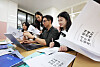 Students and teachers browse through instructions before submitting college entrance applications for the admissions for the 2027 academic year in a high school in Gyeonggi on Sept. 7.