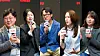 Five people hold microphones during a group interview.