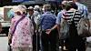 Older adults queue to receive a free meal near a public park in central Seoul on July 28.