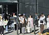 People carrying Olive Young tarpaulin bags are seen in the Hongdae neighborhood in Mapo District, western Seoul, on Sept. 15.