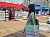 A 25-year-old Chinese tourist poses with an Olive Young tarpaulin bag.