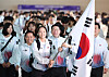 Table tennis national athlete Shin Yu-bin, center, carries the Korean flag while departing for Asian Games Aichi-Nagoya 2026 at Incheon International Airport on Sept. 17.