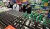 Shoppers walk past boxed carbonated drink products in a supermarket in Seoul on March 18, 2021.