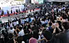 Large crowd watches a costume runway and pre-show performance inside Seoul’s National Museum of Korea.