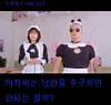Two costumed presenters pose on a decorated stage beneath Korean text.