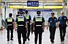 Police officers patrol inside a subway station in Gyeonggi on Aug. 4, 2023, after a series of bomb threats.
