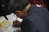 A middle-aged job seeker writes an application at an exposition held in Eunpyeong District, northern Seoul, on Sept. 1.