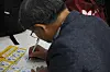 A middle-aged job seeker writes an application at an exposition held in Eunpyeong District, northern Seoul, on Sept. 1.