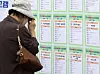 A middle-aged job seeker looks hiring notice posted at an employment exposition held in Busan on Oct. 17, 2024.