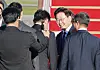 President Lee Jae Myung greets his chief of staff, Kang Hoon-sik, before boarding the presidential airplane at Seoul Air Base in Seongnam, Gyeonggi, on Sept. 21.