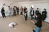 A choreographer demonstrates an AI-generated audio description for a performance through AI-platforms Midjourney and ChatGPT.