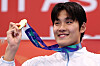 Kim Young-beom holds a gold medal after winning in a swimming competition at Asian Games Aichi-Nagoya 2026 on Sept. 21.