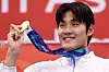 Kim Young-beom holds a gold medal after winning in a swimming competition at Asian Games Aichi-Nagoya 2026 on Sept. 21.