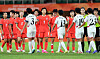 South Korean women footballers and North Korean players exchange high-fives after their women’s football group-stage match ended in a 1-1 draw in Japan on Sept. 21.