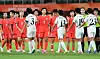 South Korean women footballers and North Korean players exchange high-fives after their women’s football group-stage match ended in a 1-1 draw in Japan on Sept. 21.