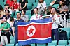 North Korean cheering squad members hold a North Korean flag during an inter-Korea match at the Asian Games Aichi-Nagoya 2026 in Japan on Sept. 21.