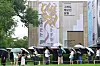 People holding umbrellas line up outside the National Museum of Modern and Contemporary Art Seoul.