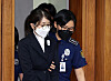 Former first lady Kim Keon Hee, left, is seen entering a chamber at the Seoul Central District Court in southern Seoul on Sept. 24, 2025.