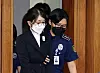Former first lady Kim Keon Hee, left, is seen entering a chamber at the Seoul Central District Court in southern Seoul on Sept. 24, 2025.