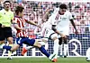 Lee Kang-in of Atlético Madrid, left, makes a hard tackle on Federico Valverde’s ankle during a match on Sept. 20 at Riyadh Air Metropolitano stadium in Madrid.