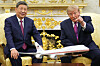 Donald Trump gestures beside Xi Jinping in the ornate Oval Office, with a model aircraft in the foreground.