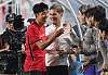 Moreno and Son Heung-min smile and exchange greetings as cameras record the moment.