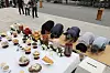 People bow beside a table of traditional Chuseok food offerings at Imjingak.
