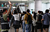 Commuters and subway officials are seen at a Seoul subway Line