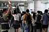 Commuters and subway officials are seen at a Seoul subway Line
