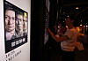 A moviegoer purchases a ticket as a digital poster for “The Assassin(s)' is appeared on a screen at a movie theater in Seoul on Sept. 28.