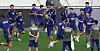 South Korea footballers and staff conduct a training session on a stadium field.