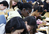International students take part in a Hangul (Korean alphabet) writing contest held on Oct. 8, 2024, at Yonsei University in Seodaemun District, western Seoul.