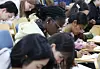 International students take part in a Hangul (Korean alphabet) writing contest held on Oct. 8, 2024, at Yonsei University in Seodaemun District, western Seoul.