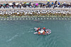 Officials use a boat and water pumps to guide the shark toward open waters at Busan North Port Waterfront Park in Busan, on Sept. 29.