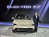 Electra E7 electric vehicle displayed onstage beside a presenter.
