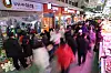 A traditional market is crowded with shoppers in 2025.