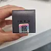 Hand holding a dark Kahi product box with an authenticity QR code sticker.