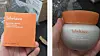 Hand holding an orange Sulwhasoo box beside a white skincare jar identified as counterfeit.