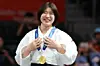 Huh Mi-mi smiles with her gold medal during the women’s 57-kilogram medal ceremony at the Aichi International Arena in Nagoya, Japan, on Oct. 1.
