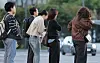 People wearing outer jackets are spotted on a cross walk in central Seoul on Oct. 6.