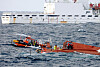 A 29-ton fishing boat lies capsized about 65 kilometers (40 miles) northwest of Chagwi Island, Jeju, on Monday.