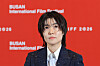 Shim Eun-kyung poses against a red Busan International Film Festival backdrop.