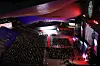A crowded auditorium faces a brightly lit stage during the Busan International Film Festival opening ceremony.