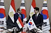 President Lee Jae Myung, left, shakes hands with Egyptian President Abdel Fattah El-Sisi at the Blue House in central Seoul on Oct. 8.
